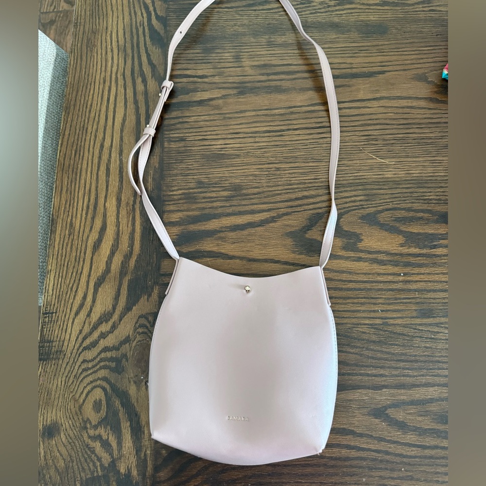 Small pink purse. Crossbody or one shoulder. Great used condition,small smudge.